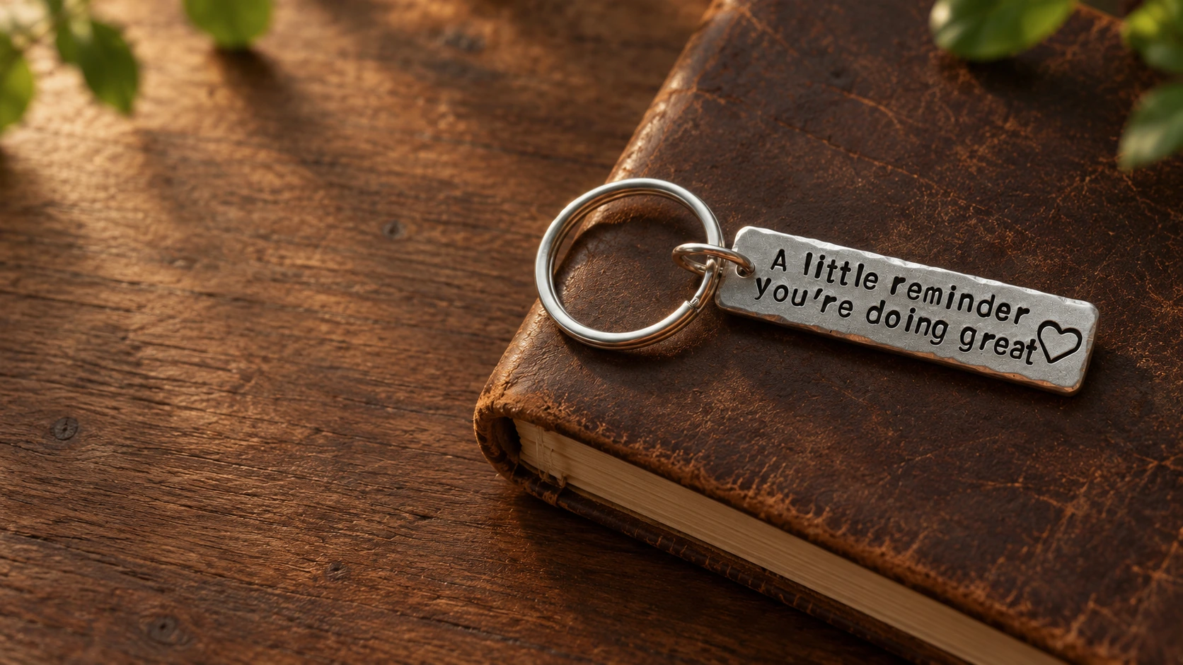 Engraved keychain resting on dark brown leather